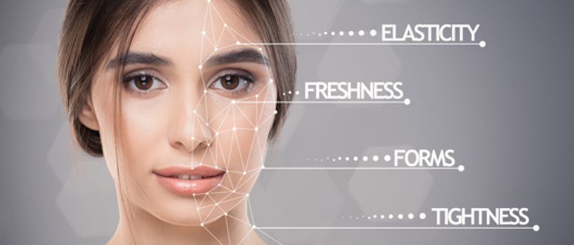 Portrait of young pretty lady with skin featers marks over grey background, healthy skin and skincare concept